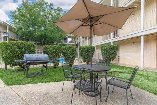 a view of a table and chairs under an umbrella