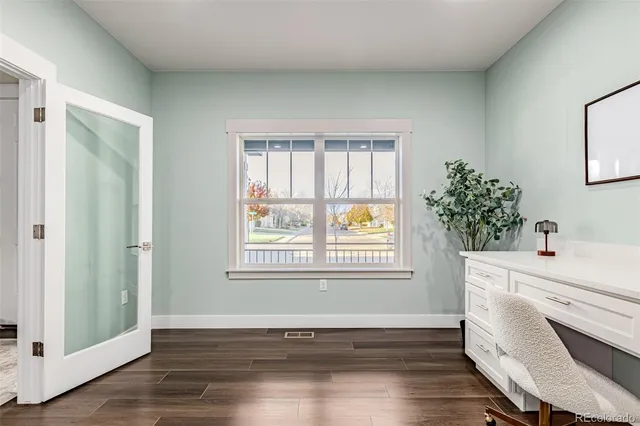 a room with a window and wooden floor