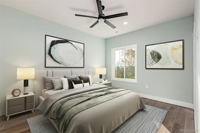 a bedroom with a bed and a painting on the wall