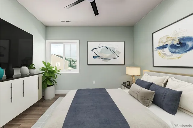 a bedroom with furniture and a potted plant