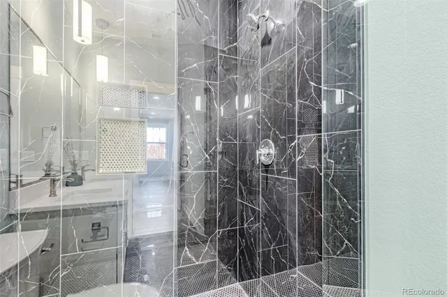 a bathroom with a shower and a sink