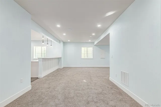 an empty room with windows and pillars in it