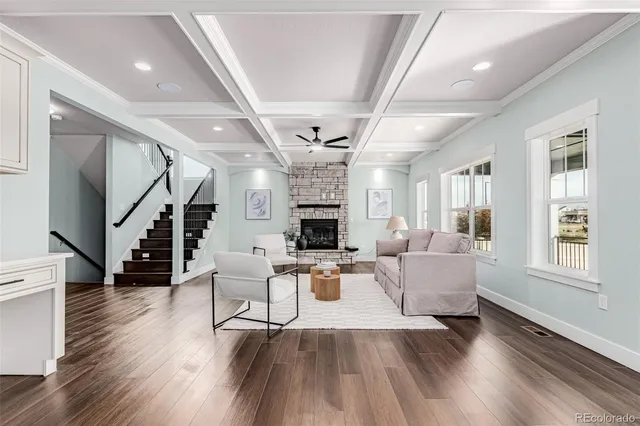 a living room with fireplace furniture and a wooden floor