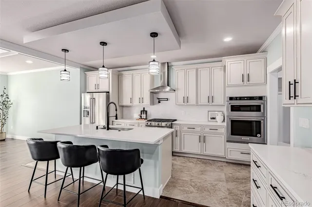 a kitchen with stainless steel appliances kitchen island granite countertop a stove a sink and a refrigerator