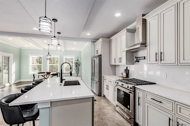 a kitchen with kitchen island a counter space a sink stainless steel appliances and cabinets