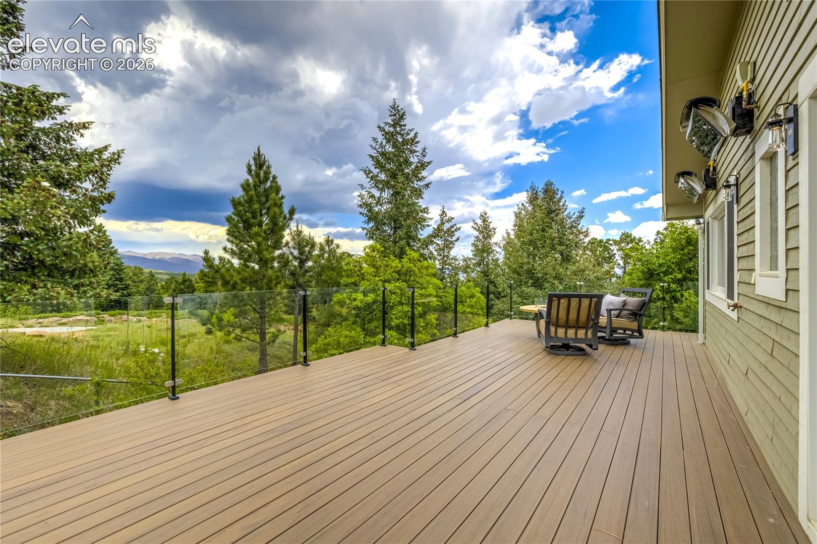 3 Thayer Road Colorado Springs, CO 80906 - Photo 45 of 50 Expansive outdoor living captures breathtaking city light, mountain, and sunset views.