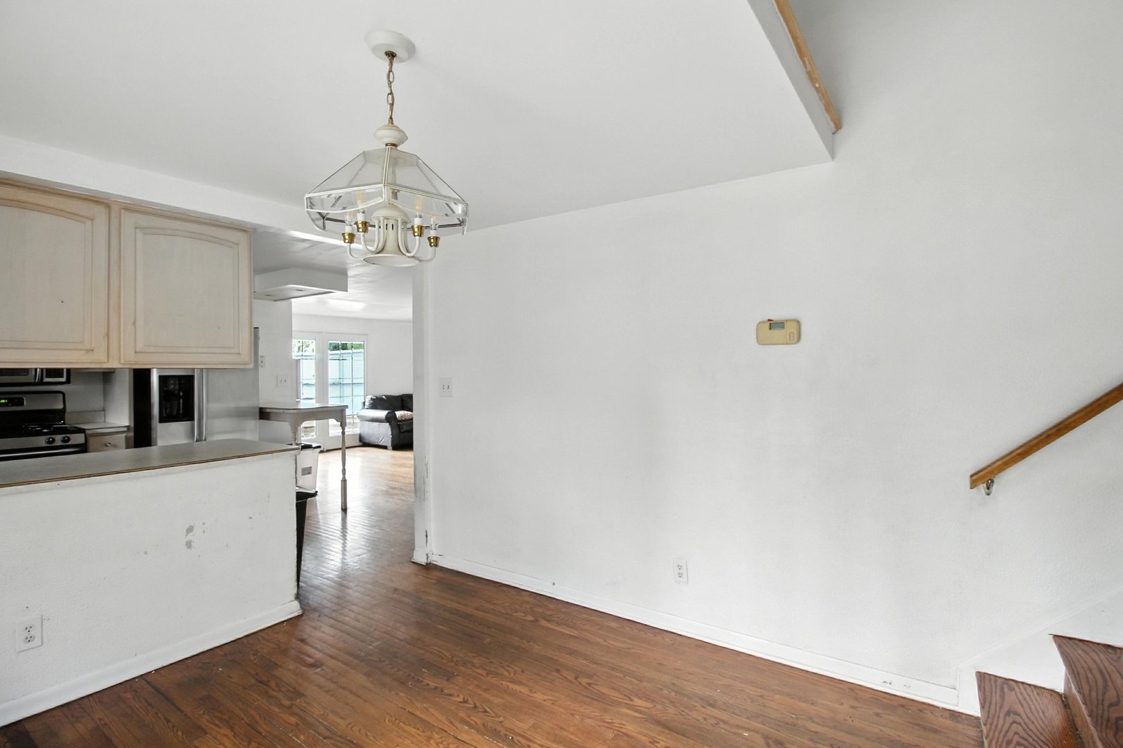 406 Madison Street Joliet, IL 60435 - Photo 16 of 40 a large kitchen with a white cabinets and wooden floor