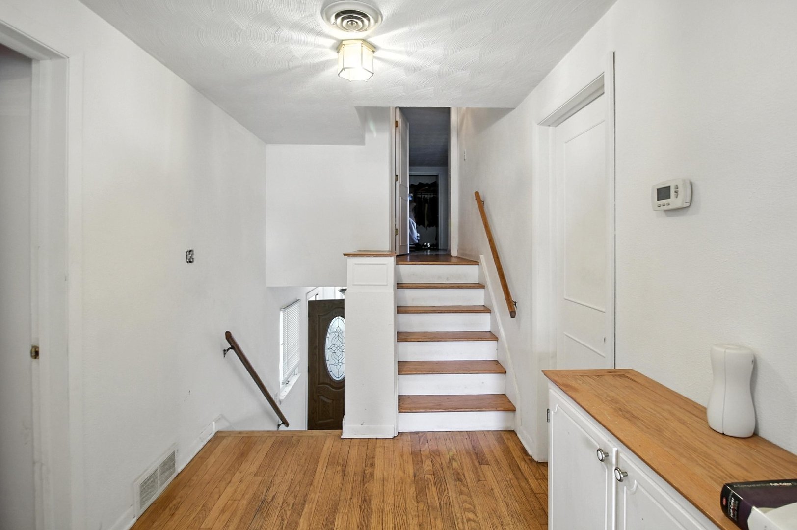 406 Madison Street Joliet, IL 60435 - Photo 23 of 40 a view of a hallway with wooden floor and staircase