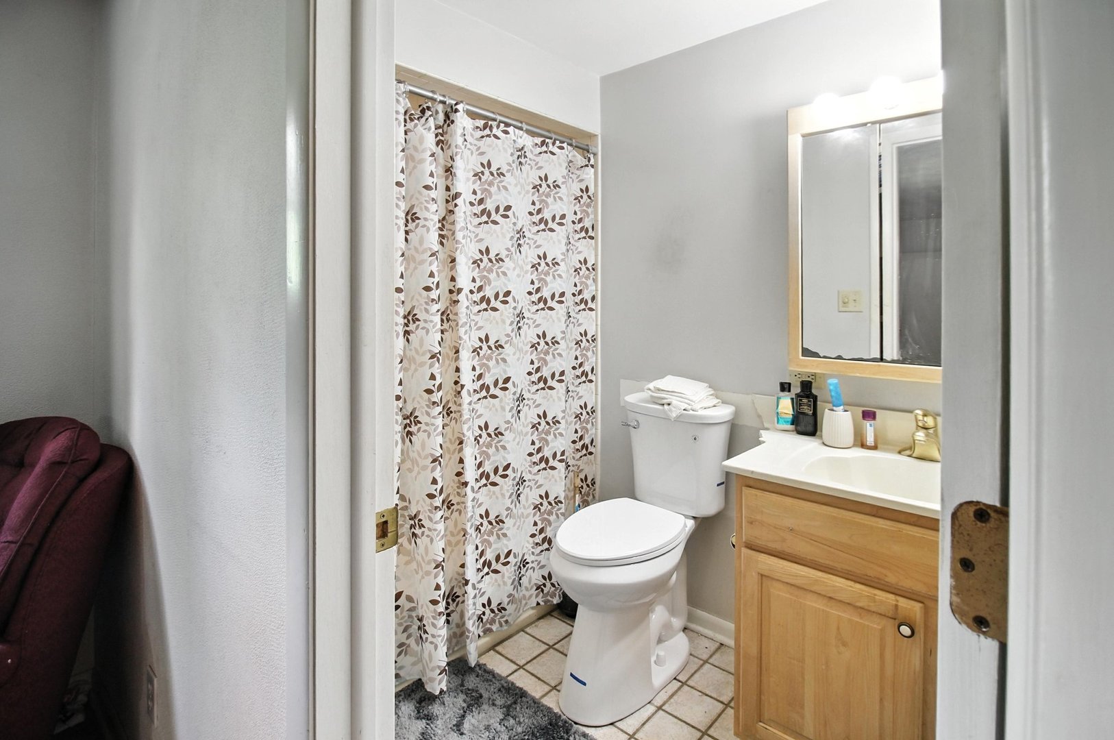 406 Madison Street Joliet, IL 60435 - Photo 31 of 40 a bathroom with a toilet and a shower curtain