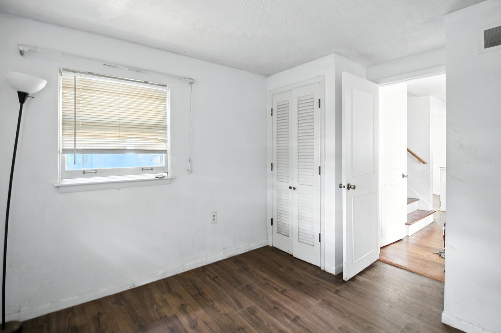 406 Madison Street Joliet, IL 60435 - Photo 35 of 40 a view of an empty room with wooden floor and a window