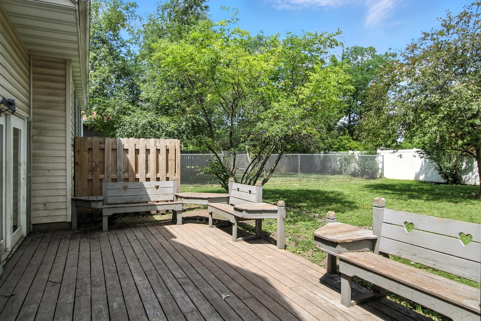 406 Madison Street Joliet, IL 60435 - Photo 37 of 40 a view of a deck with chairs a barbeque with wooden floor and fence