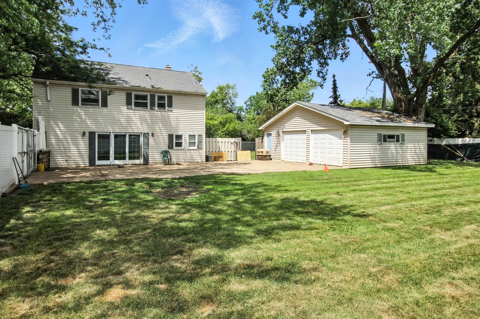 406 Madison Street Joliet, IL 60435 - Photo 5 of 40 a front view of a house with a garden and trees