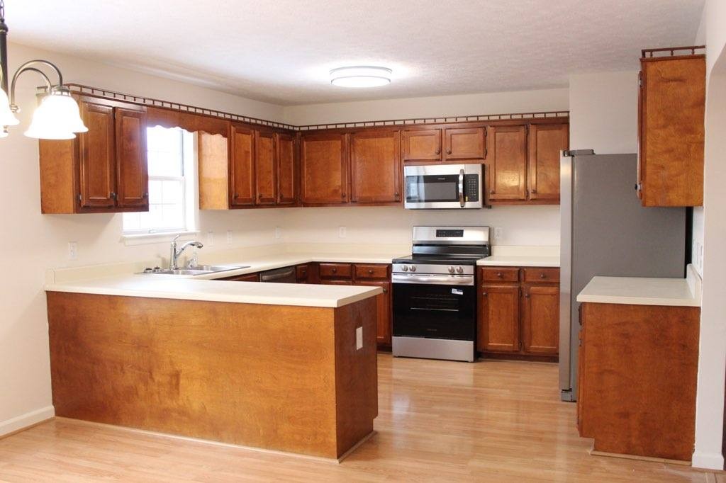 803 Red Hollow Drive Springfield, TN 37172 - Photo 7 of 9 a kitchen with stainless steel appliances granite countertop a stove a sink dishwasher and a refrigerator with wooden floor