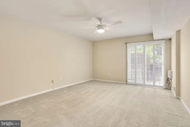 an empty room with chandelier fan