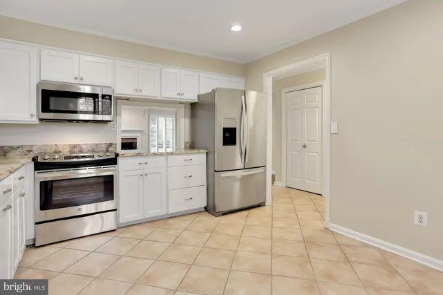 a kitchen with stainless steel appliances a stove a microwave and a refrigerator