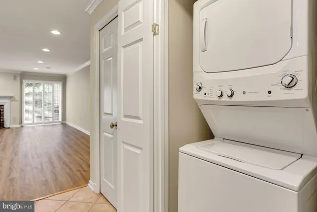 a view of washer and dryer with bathroom in the background