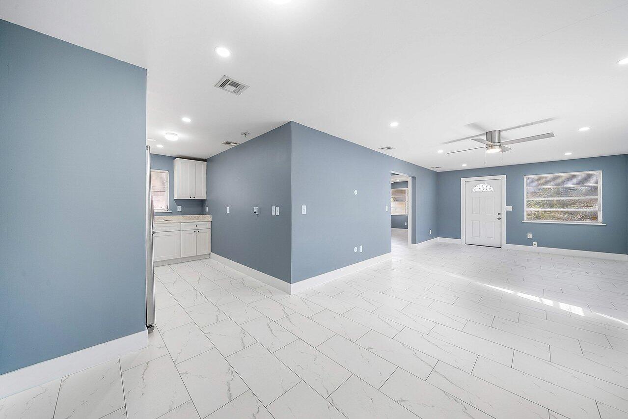 3527 Kirk Road Lake Worth, FL 33461 - Photo 13 of 25 a view of empty room with kitchen and window