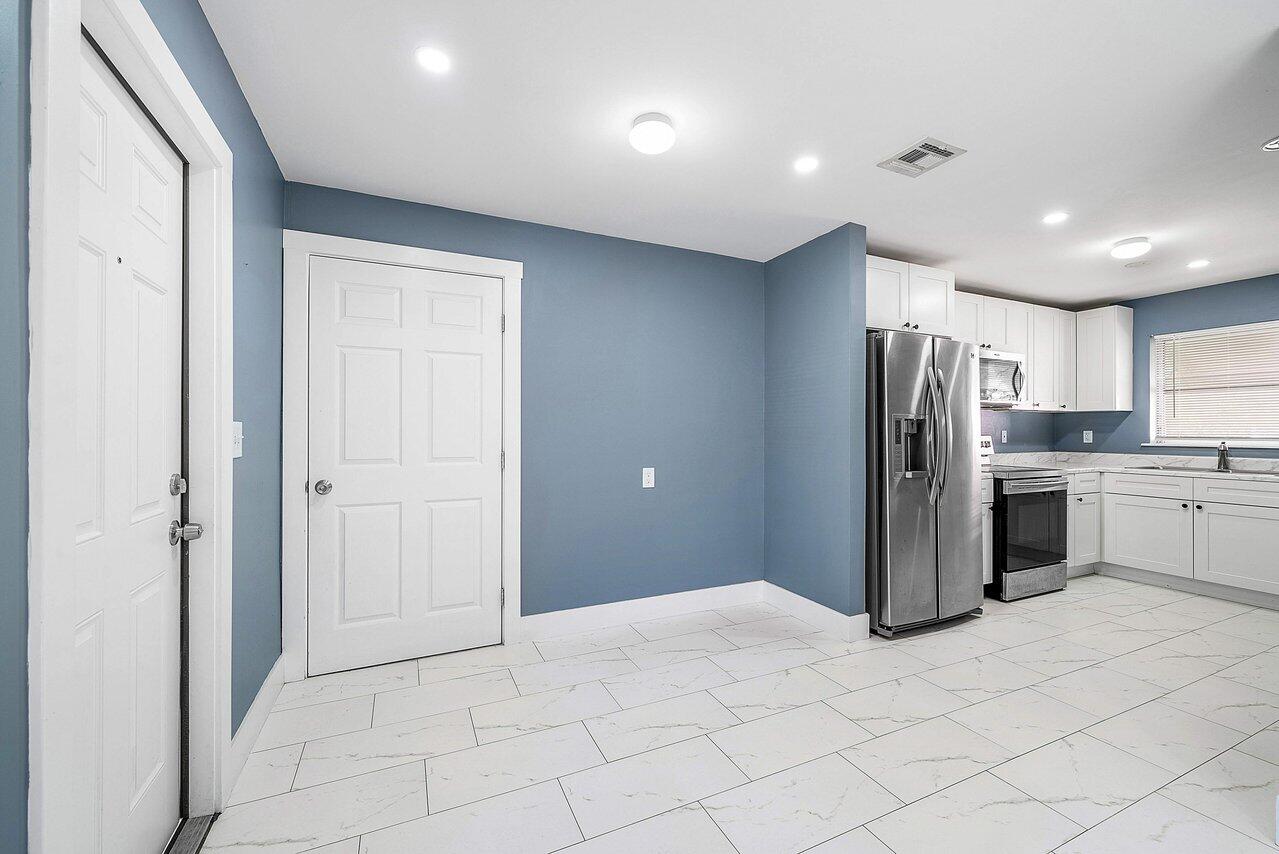 3527 Kirk Road Lake Worth, FL 33461 - Photo 14 of 25 a kitchen with stainless steel appliances kitchen island granite countertop a refrigerator and a sink