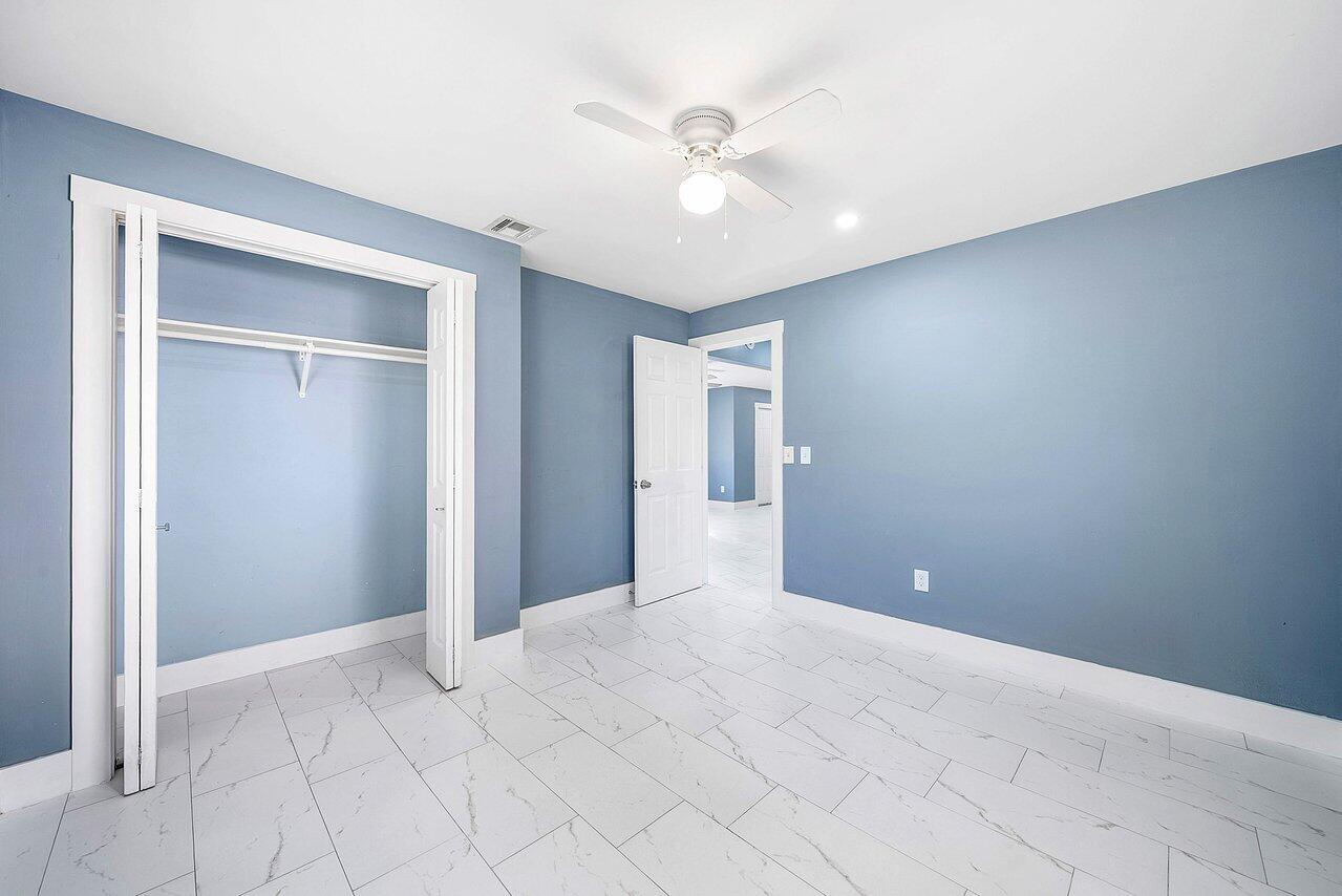 3527 Kirk Road Lake Worth, FL 33461 - Photo 19 of 25 a view of an empty room with a ceiling fan