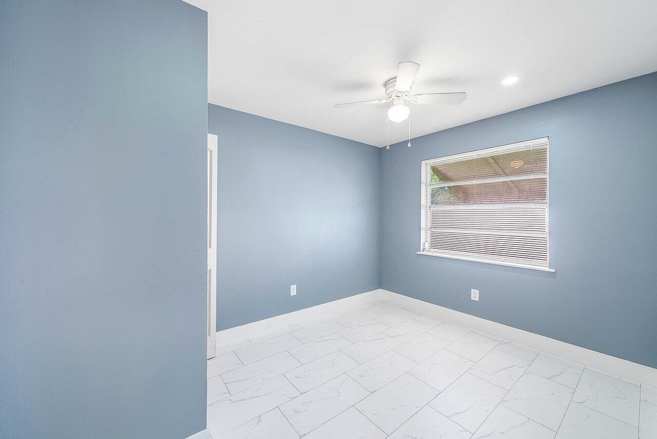 3527 Kirk Road Lake Worth, FL 33461 - Photo 21 of 25 a view of a livingroom with a ceiling fan and window