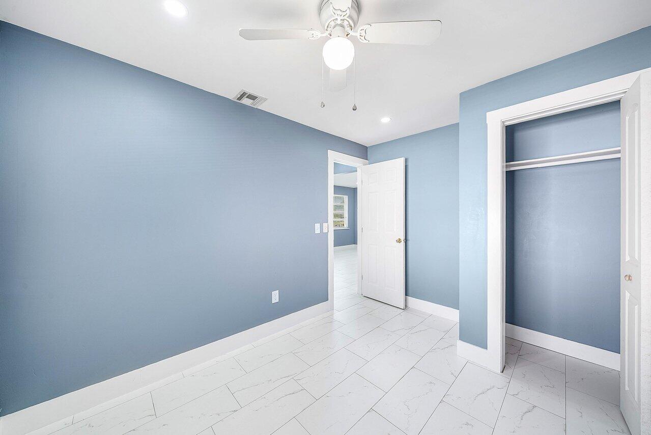 3527 Kirk Road Lake Worth, FL 33461 - Photo 22 of 25 an empty room with fan and entrance