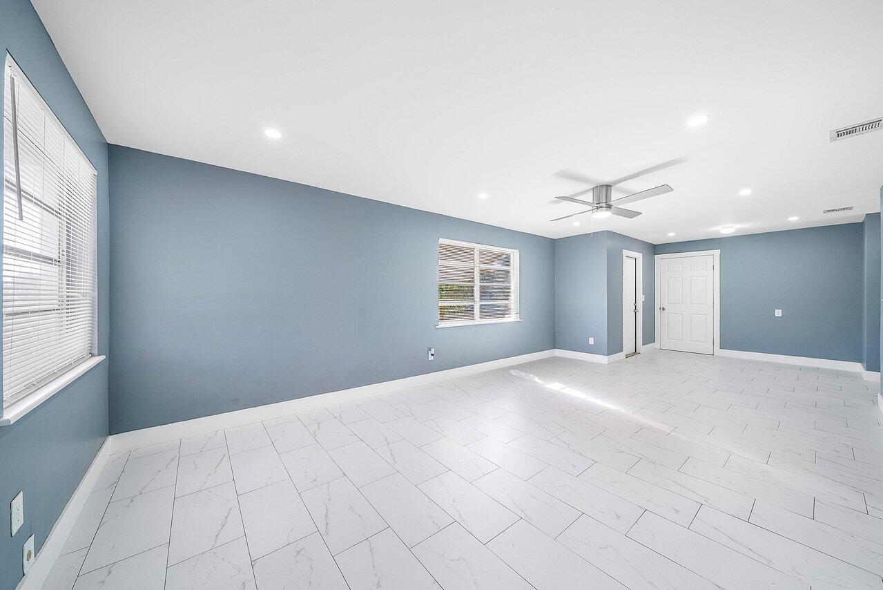 3527 Kirk Road Lake Worth, FL 33461 - Photo 9 of 25 a view of a livingroom with a ceiling fan and window
