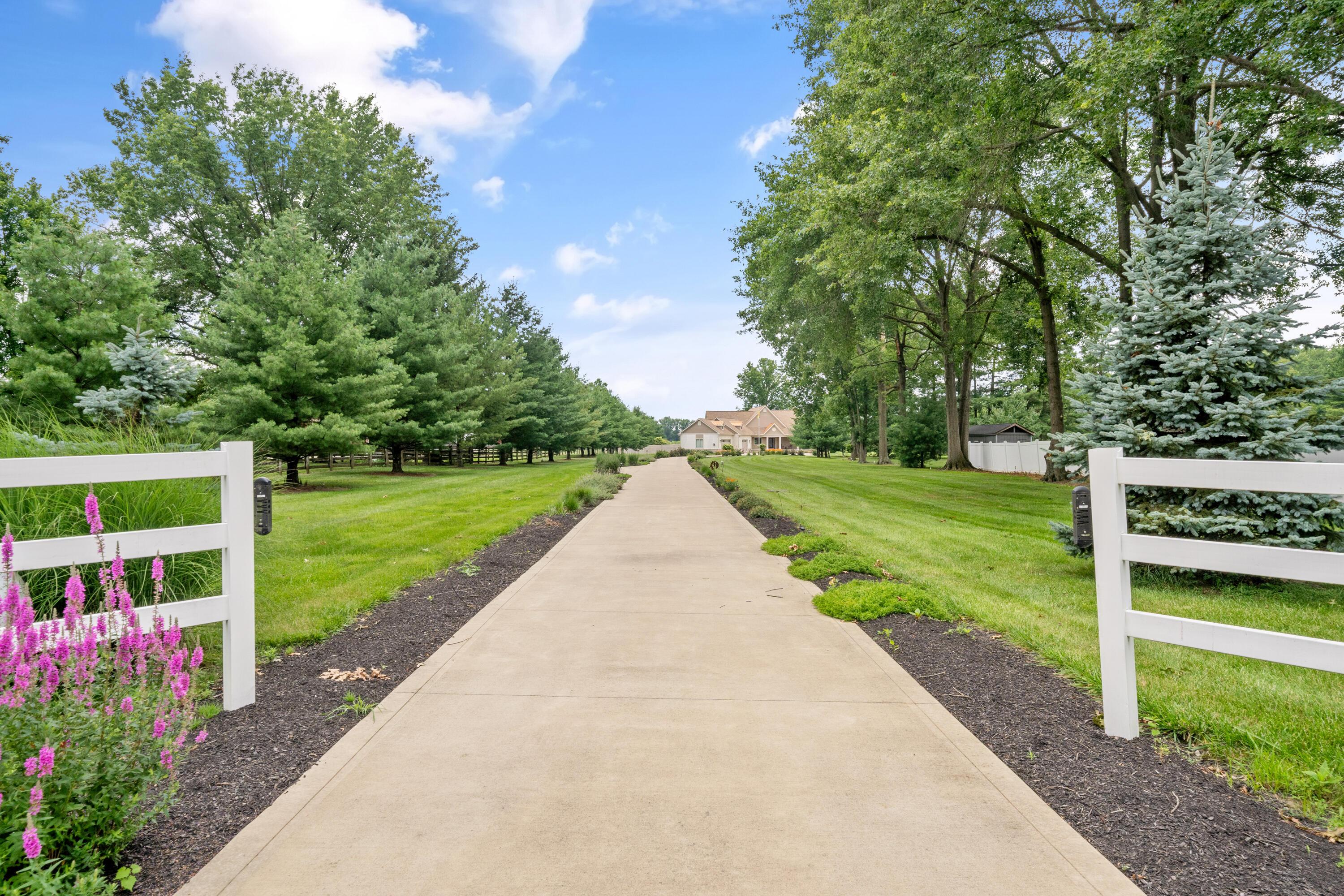 4640 Maynard Road Delaware, OH 43015 - Photo 58 of 91 Long concrete driveway with white fence posts