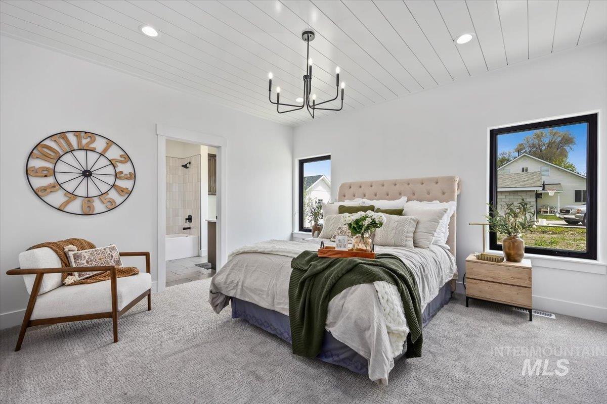 107 3rd Street West Declo, ID 83323 - Photo 15 of 25 Spacious bedroom featuring planked ceiling treatment, recessed lighting, and a contemporary black chandelier