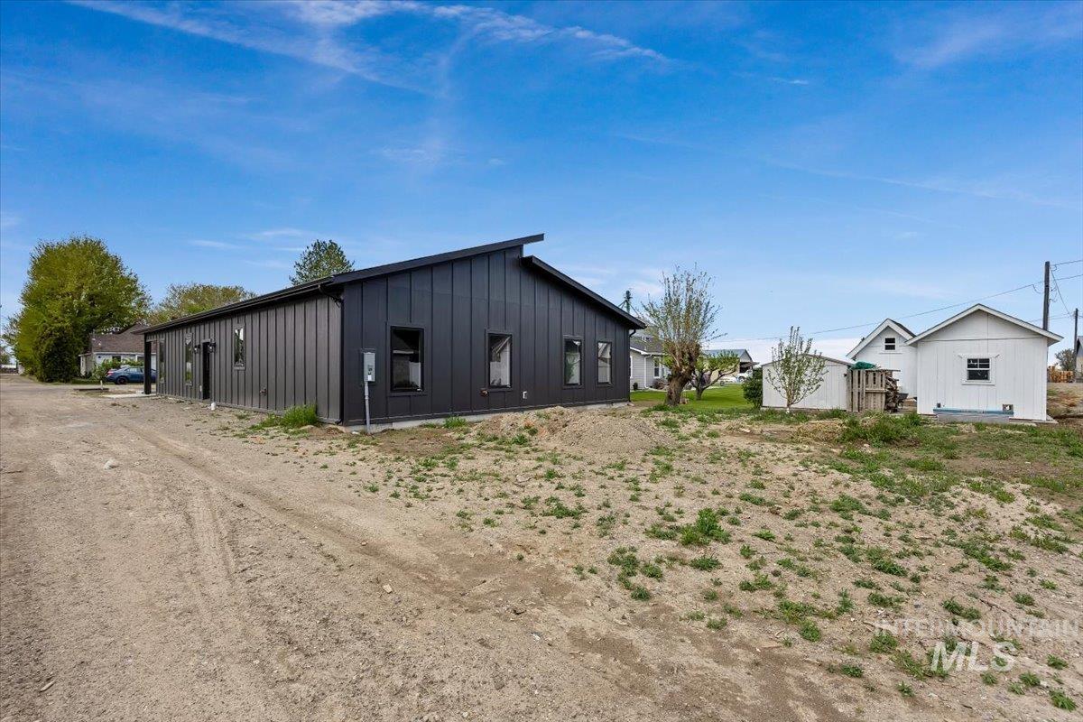 107 3rd Street West Declo, ID 83323 - Photo 24 of 25 Contemporary black vertical siding with a low-slope roofline and dark-framed windows