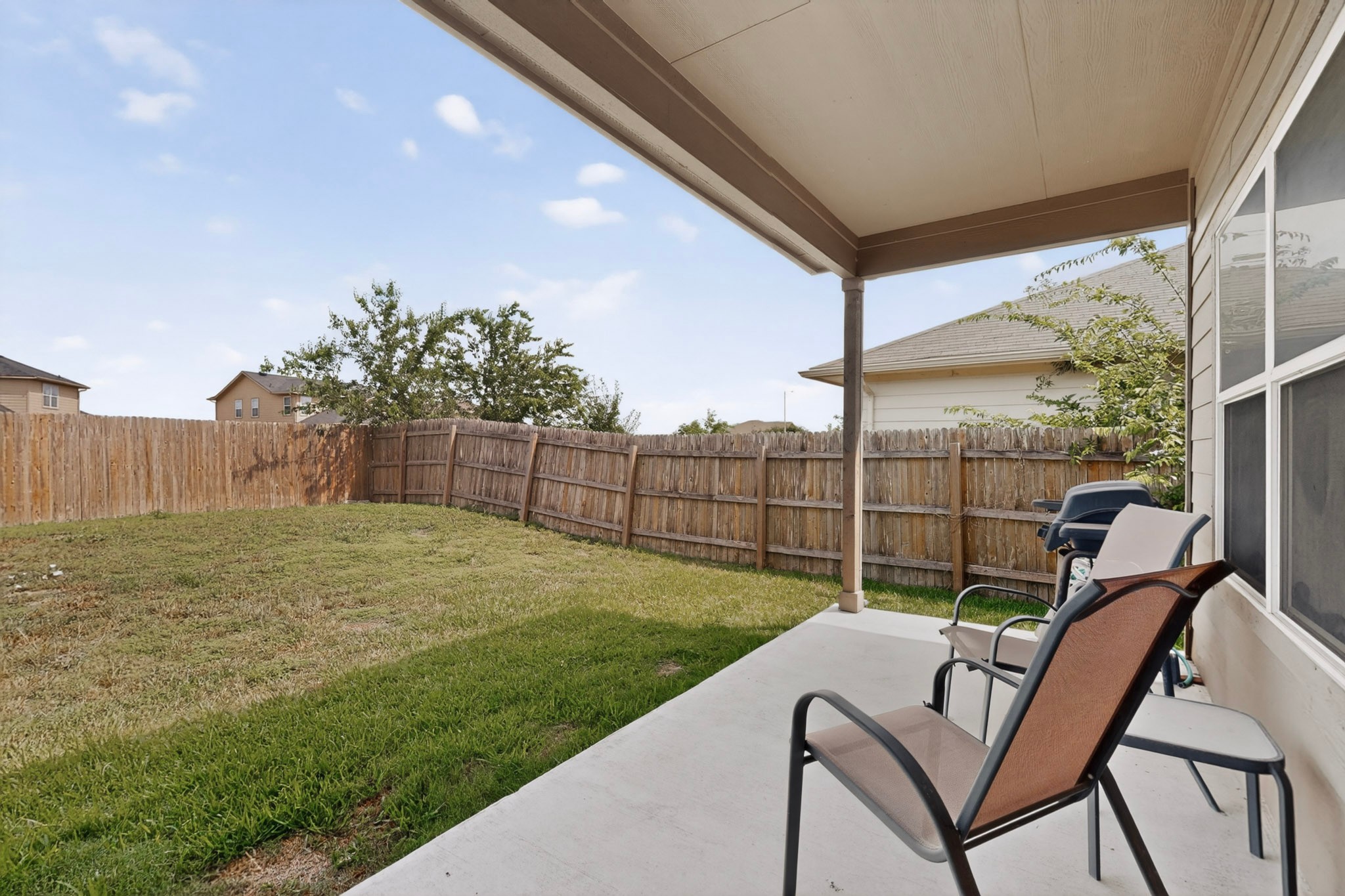 14513 Esker Road Manor, TX 78653 - Photo 30 of 38 An inviting covered patio opens to a spacious, private yard, perfect for outdoor enjoyment.