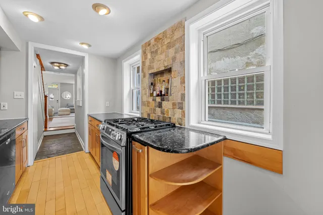 a large kitchen with granite countertop a stove and a sink