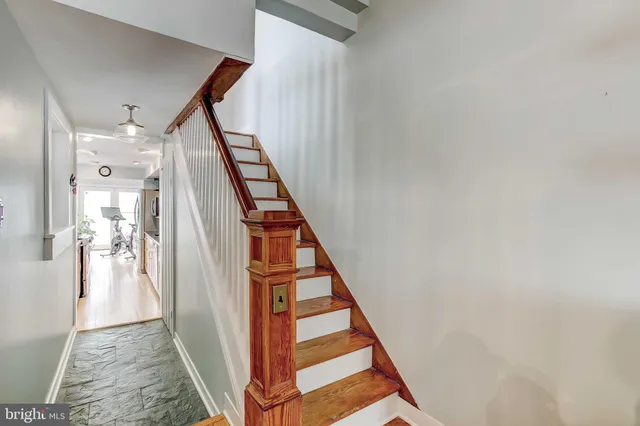 a bathroom with a toilet sink vanity and mirror