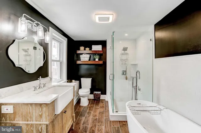 a bathroom with a sink mirror and toilet