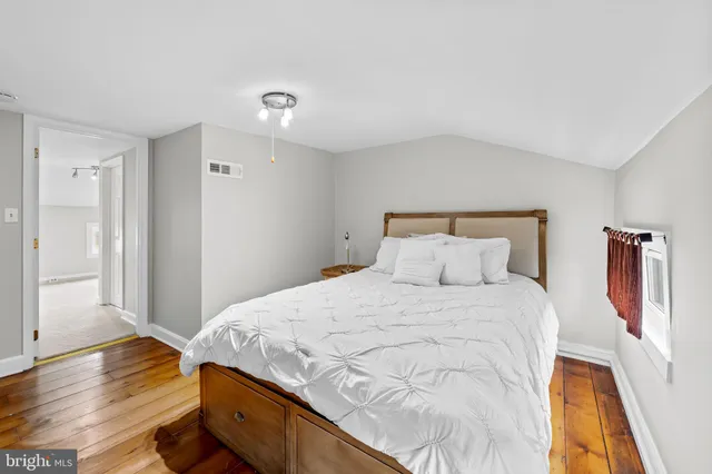 a bedroom with a bed and a lamp