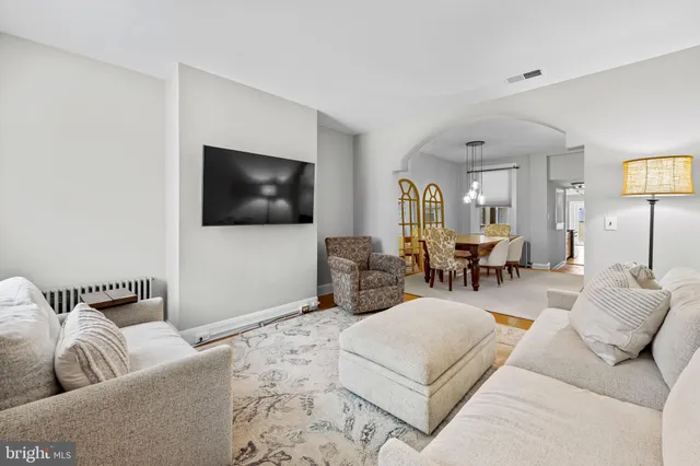 a view of a dining room with furniture and a chandelier