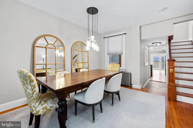 a view of a dining room with furniture and a chandelier