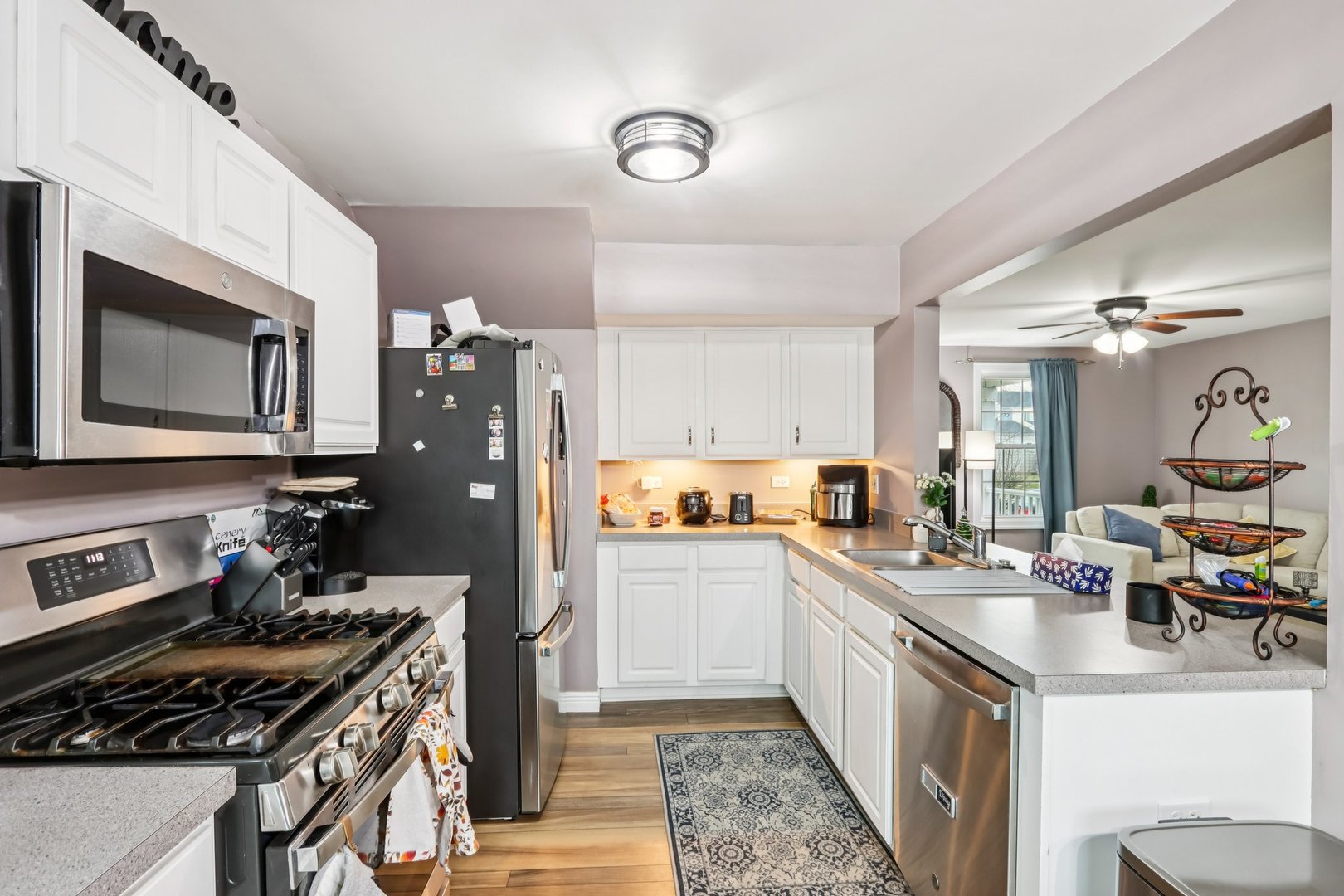 1010 Symphony Drive Aurora, IL 60504 - Photo 11 of 28 a kitchen with a stove a sink and a refrigerator