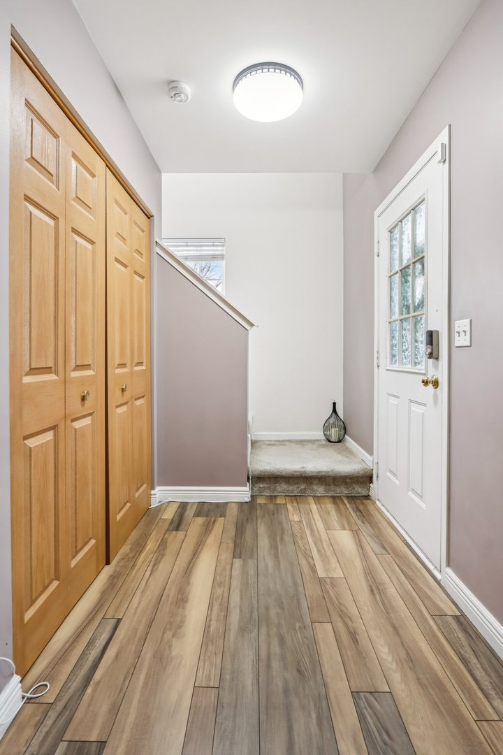 1010 Symphony Drive Aurora, IL 60504 - Photo 12 of 28 wooden floor in an empty room with a window