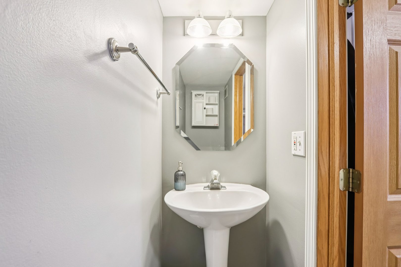 1010 Symphony Drive Aurora, IL 60504 - Photo 15 of 28 a bathroom with a sink and a mirror
