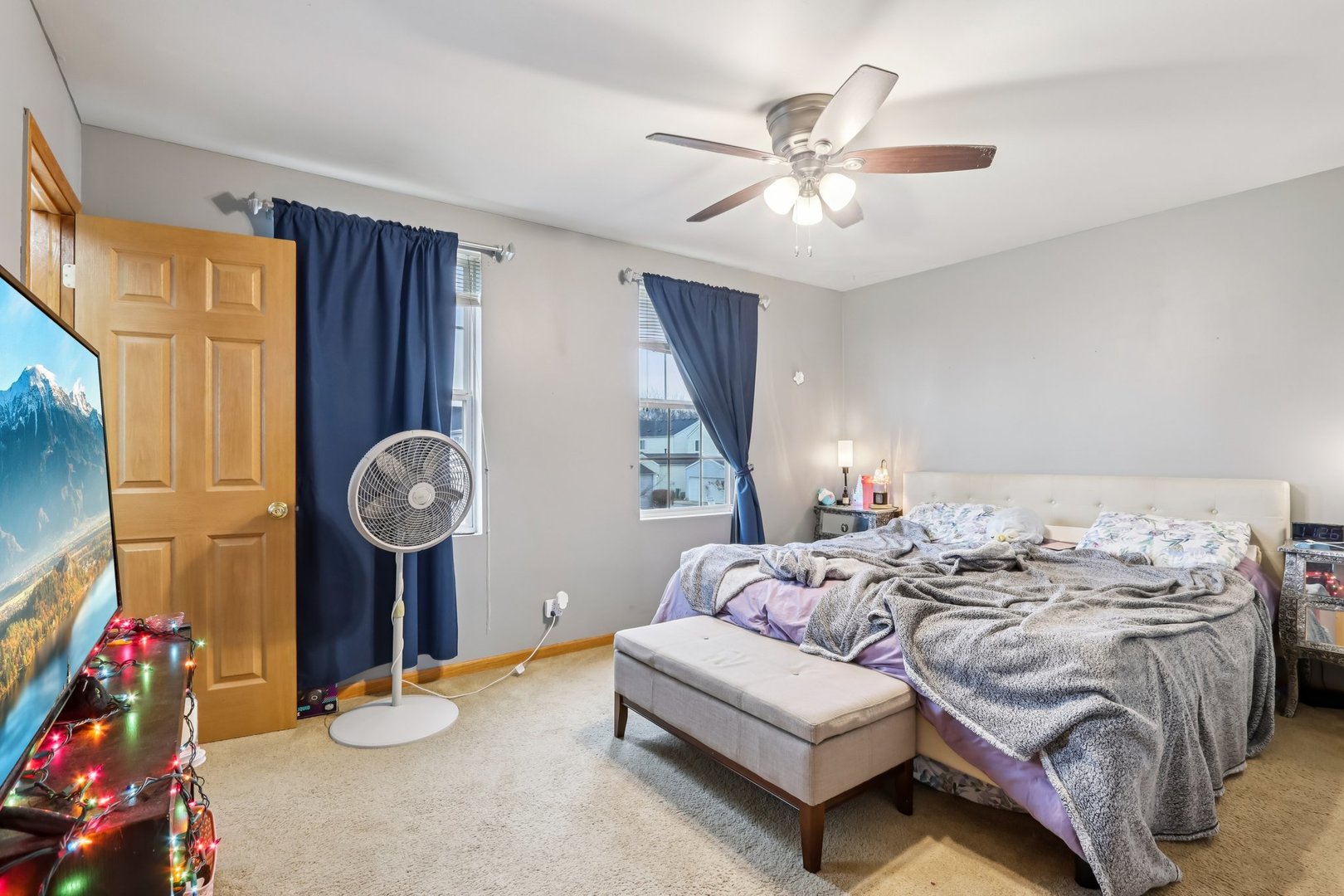 1010 Symphony Drive Aurora, IL 60504 - Photo 17 of 28 a bedroom with a bed and a chandelier