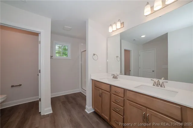 a spacious bathroom with a double vanity sink and a mirror