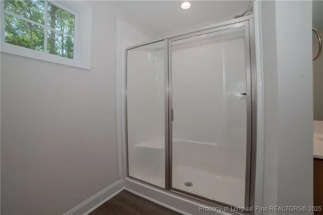 a bathroom with a glass shower door