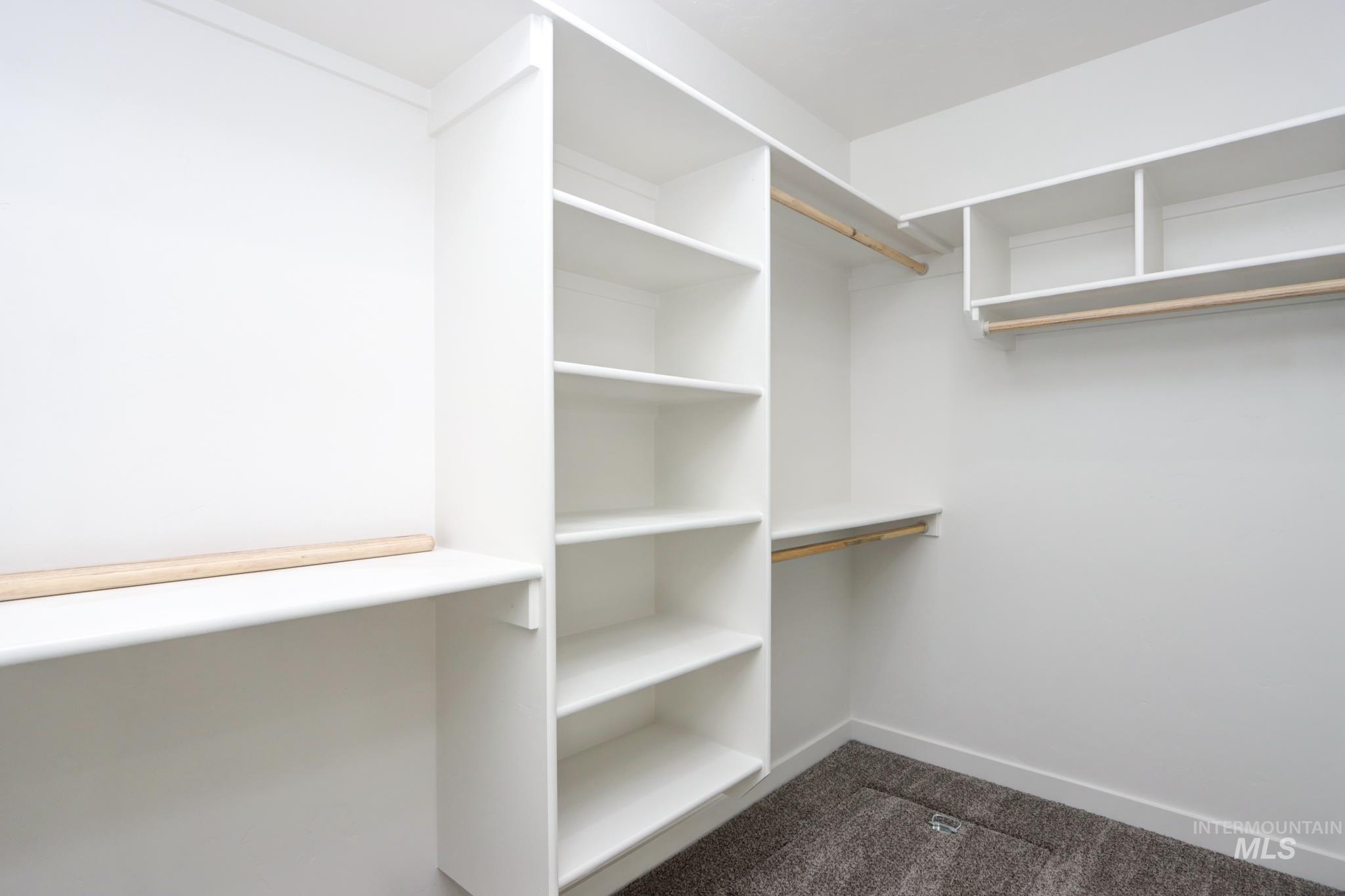 848 North 5th Street Nyssa, OR 97913 - Photo 17 of 49 Custom closet system featuring white shelving and natural wood hanging rods, providing extensive organization options