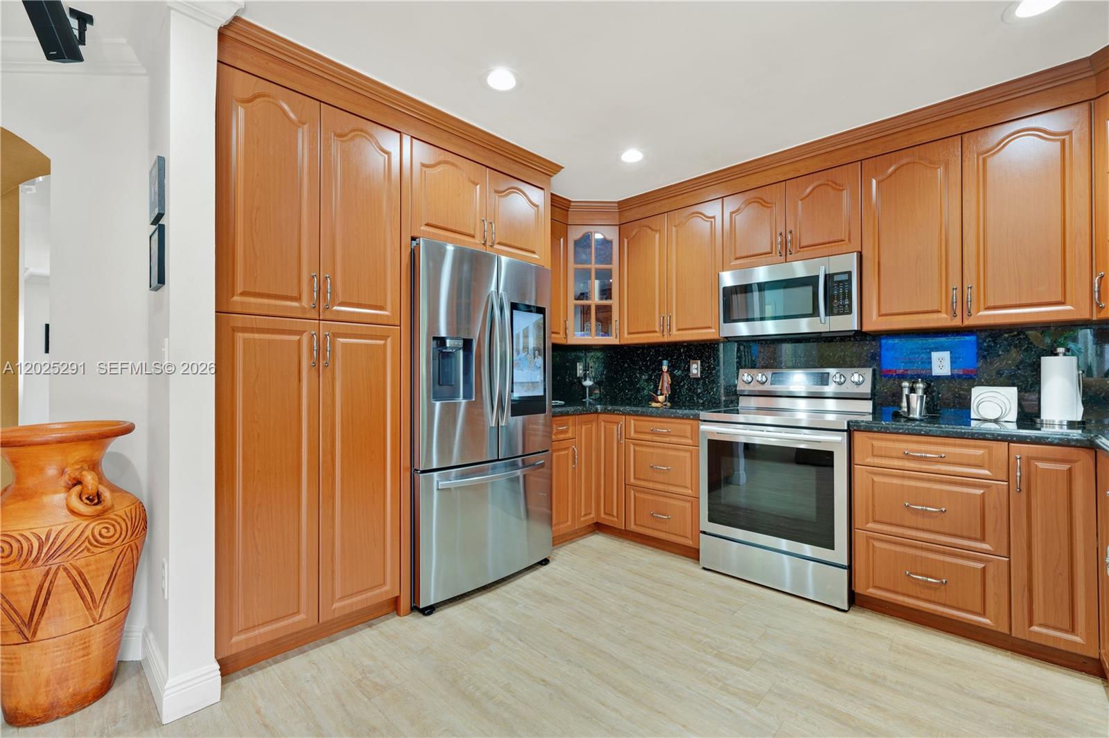 10006 Southwest 162nd Path Miami, FL 33196 - Photo 16 of 40 a kitchen with stainless steel appliances granite countertop a refrigerator stove and sink