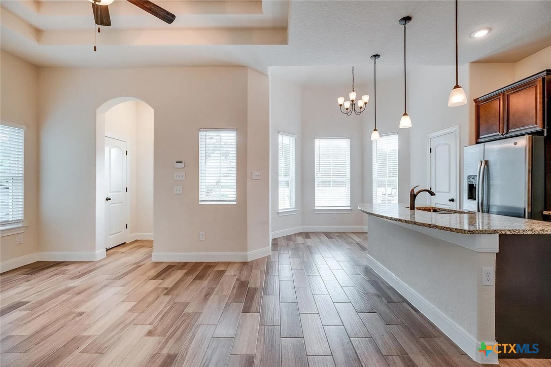 3133 Puter Creek Road, Unit B Spring Branch, TX 78070 - Photo 3 of 19 a view of a kitchen with wooden floor and a sink