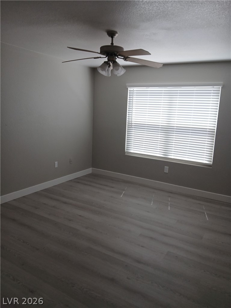 555 East Silverado Ranch Boulevard, Unit 1098 Las Vegas, NV 89183 - Photo 5 of 10 Laminate wood flooring and a refreshing ceiling fan create comfort in this spacious bedroom.