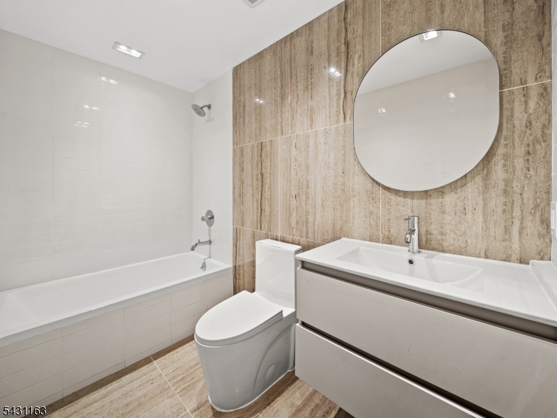 100 Chestnut Street, Unit 3 West Orange, NJ 07052 - Photo 13 of 18 a bathroom with a toilet a sink and bathtub