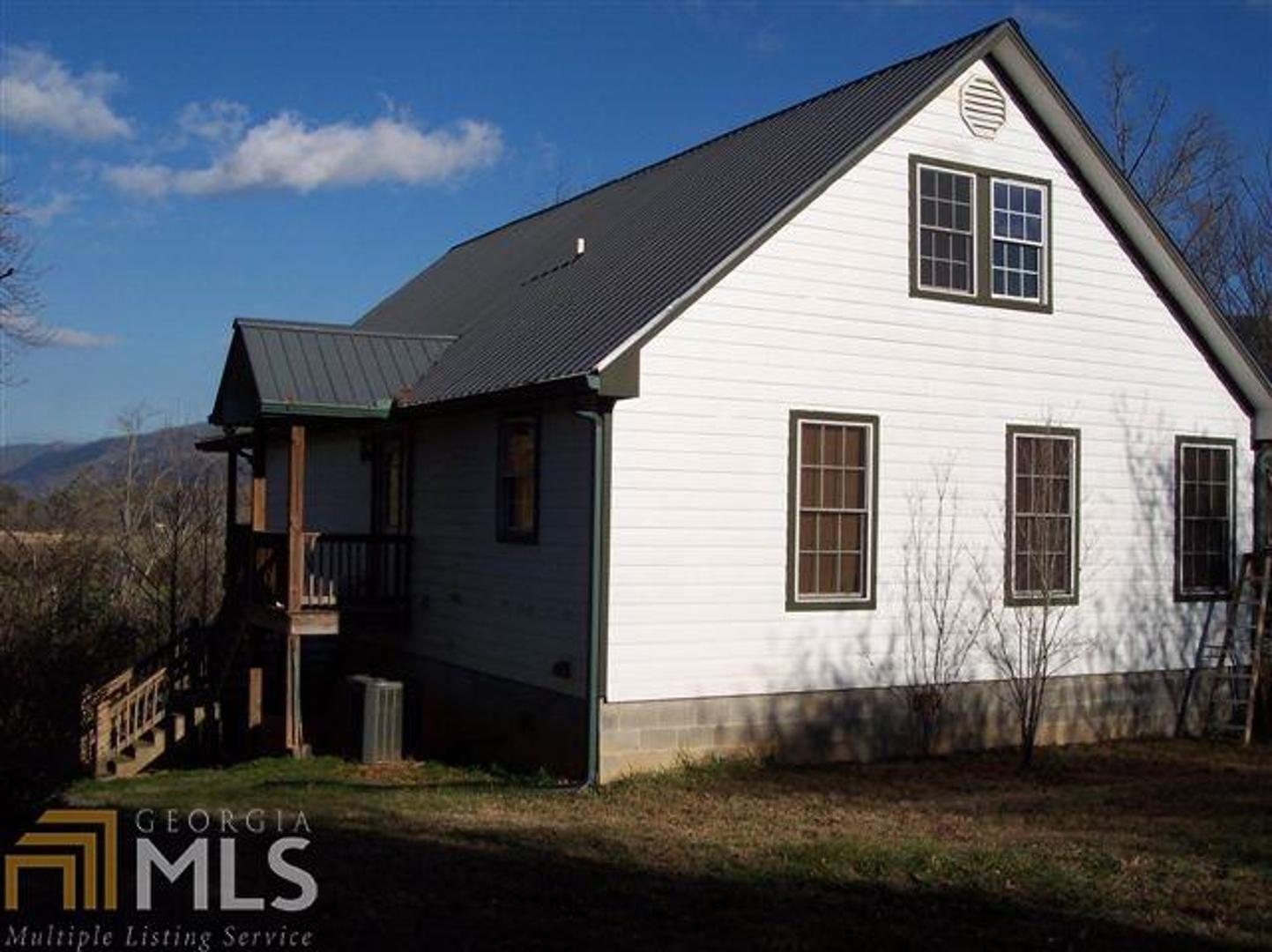 586 Wolffork Church Road Rabun Gap, GA 30568 - Photo 1 of 1 a front view of a house with a yard