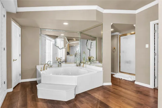 a bathroom with a double vanity sink a mirror and a bathtub