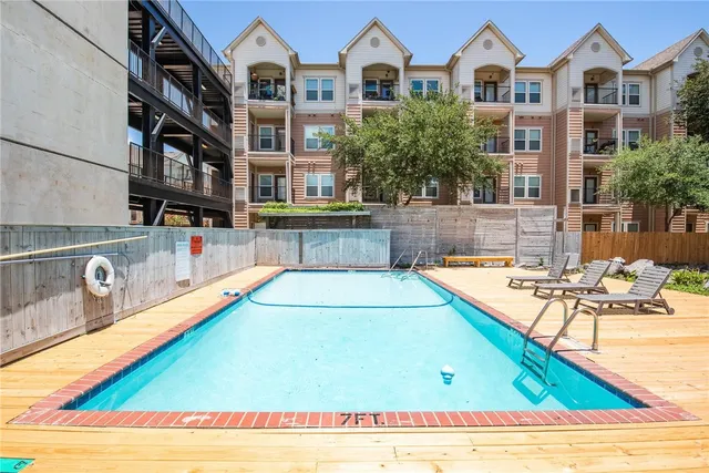 a view of a swimming pool with outdoor seating